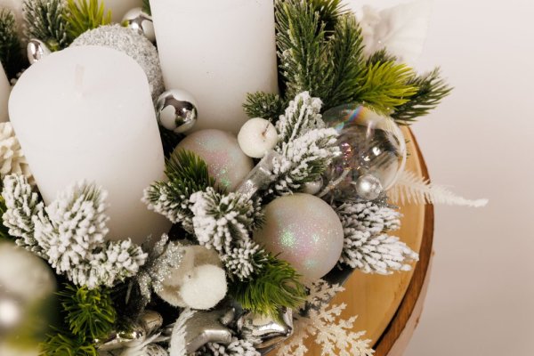 krásny elegantný adventný veniec so striebornými dekoráciami a bielymi sviecami 